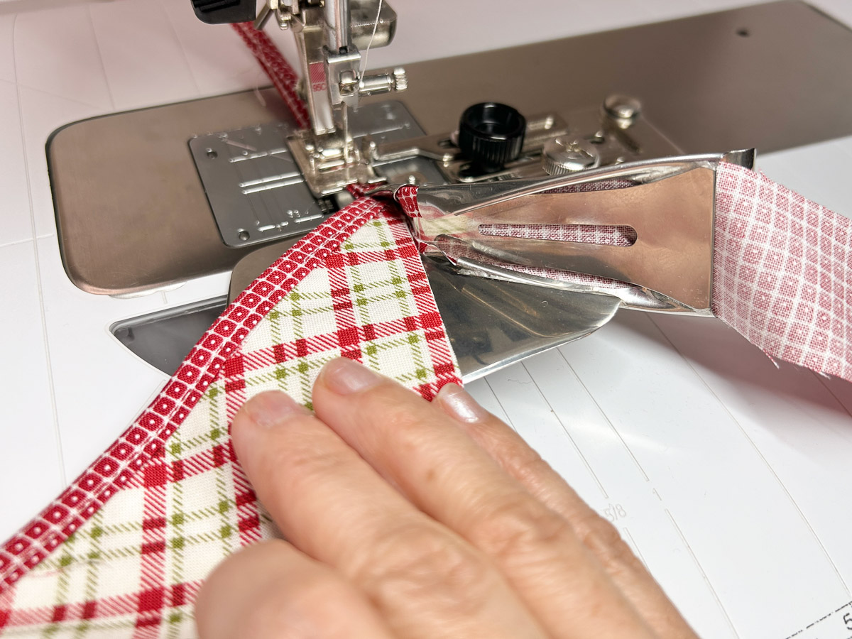 close up view of the cut ends being pushed through the binder attachment.