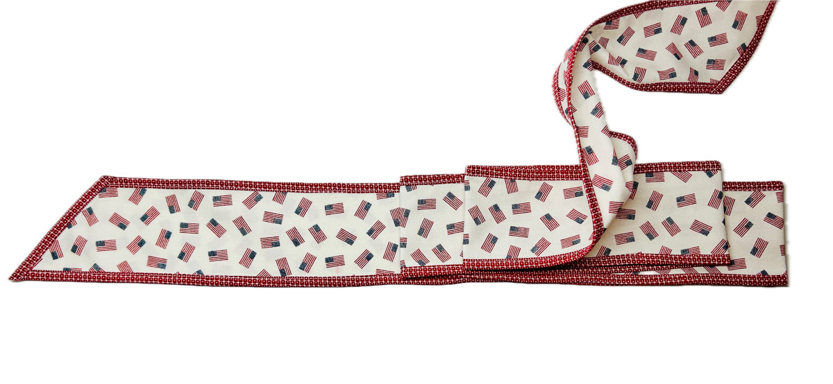 white bow with flags arranged with accordion folds on a white background.