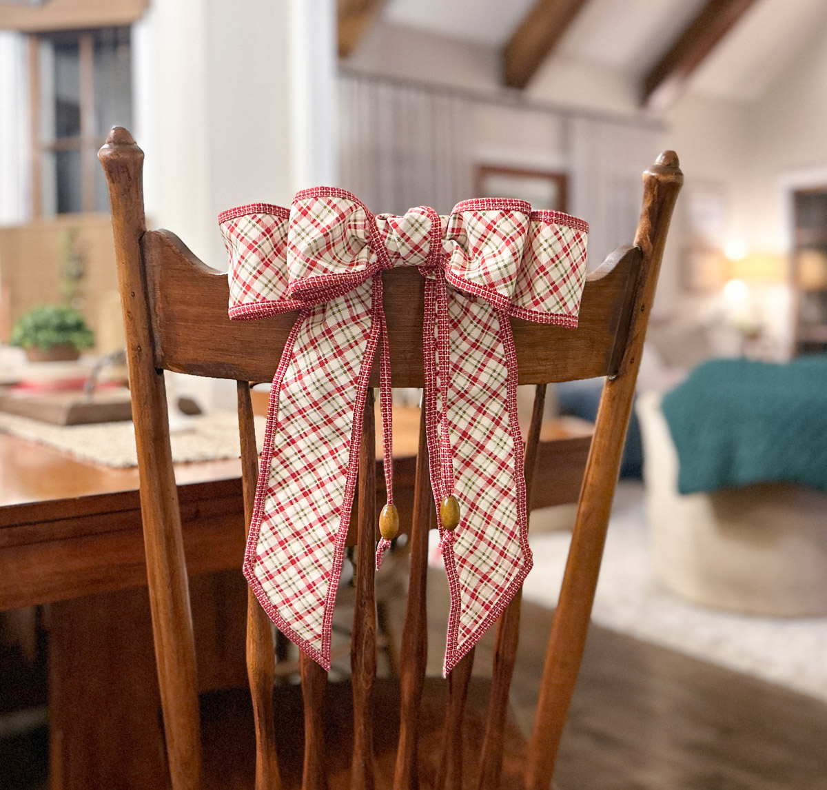 red plaid bow with wooden beads on a white background.