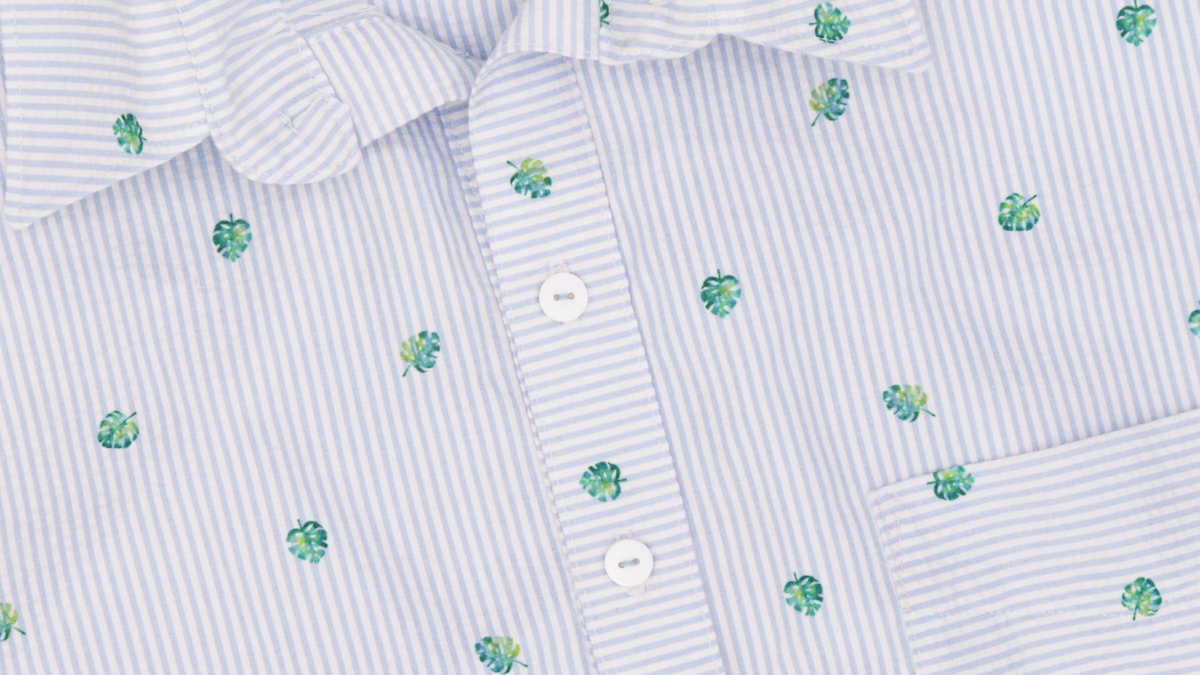 A close up of a shirt with embroidered buttons