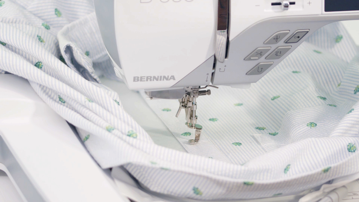 View of buttonholes being embroidered on a shirt