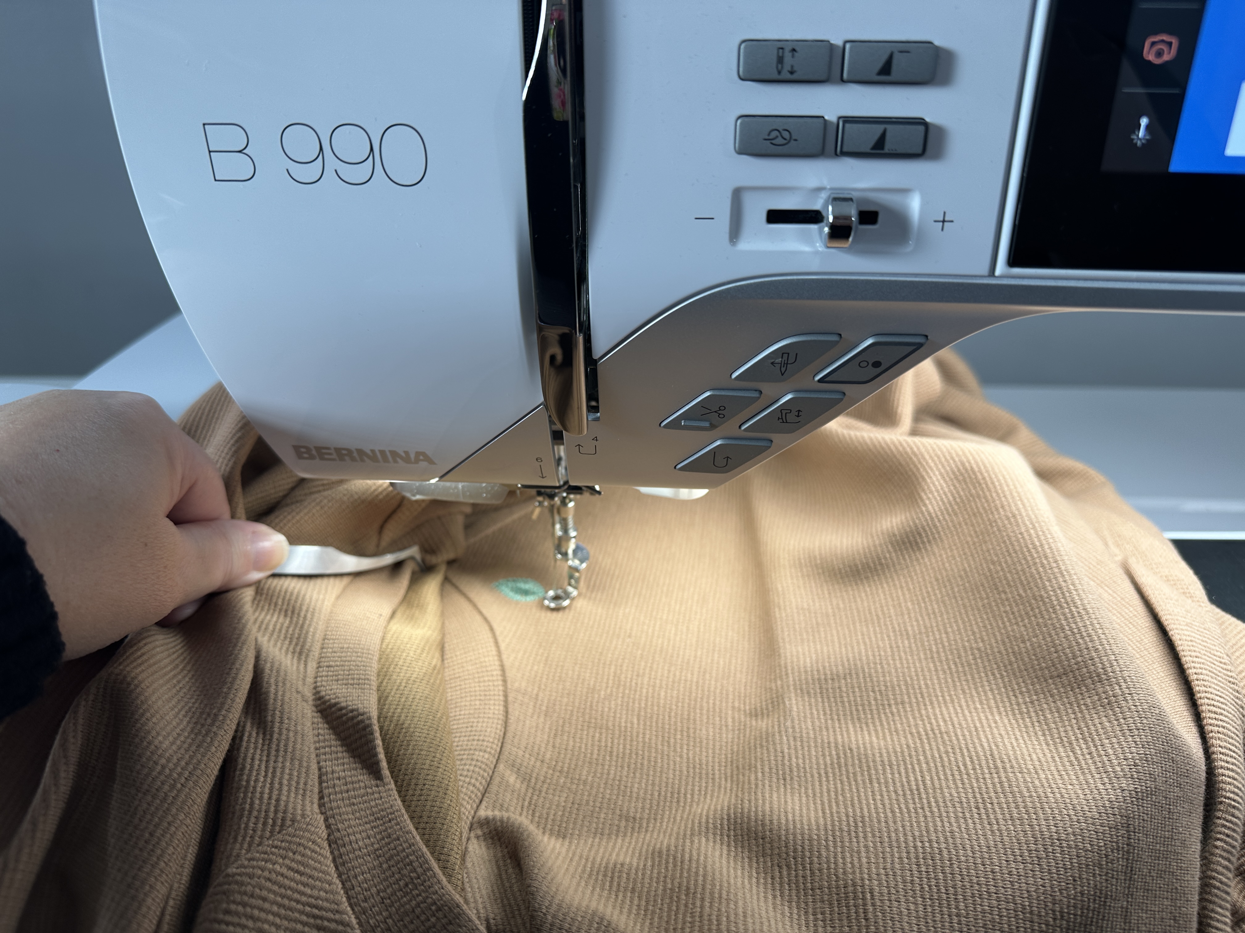 Using tweezers to manage fabric on B990
