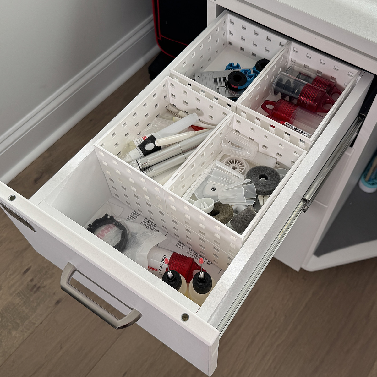 I keep the supplies I use every day when I sew in the top drawer.  Things like oil pens, brushes, spool caps, and stitch plates.  I always want these supplies nearby.