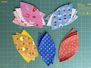 applique pieces piled on green background
