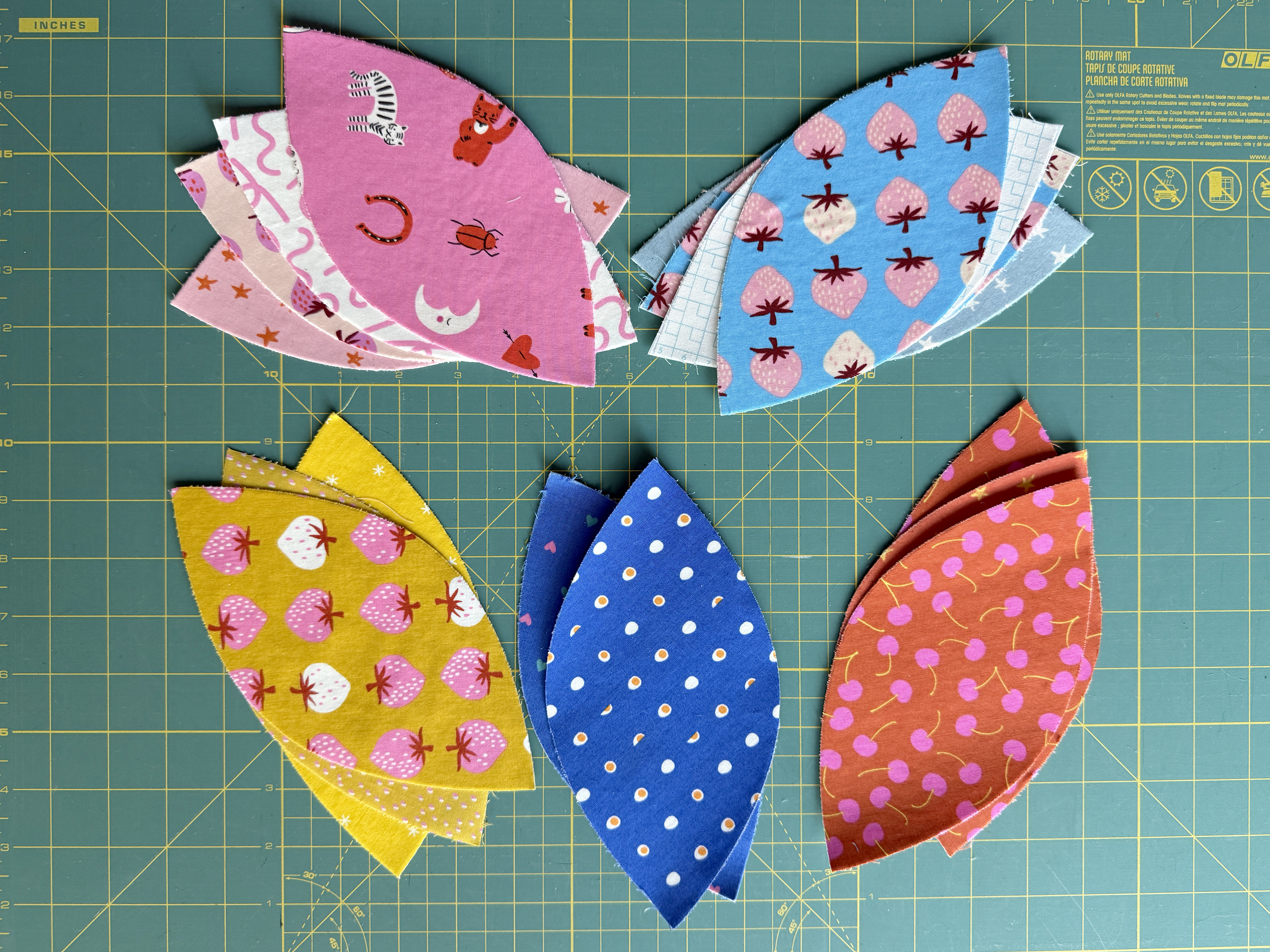 applique pieces piled on green background