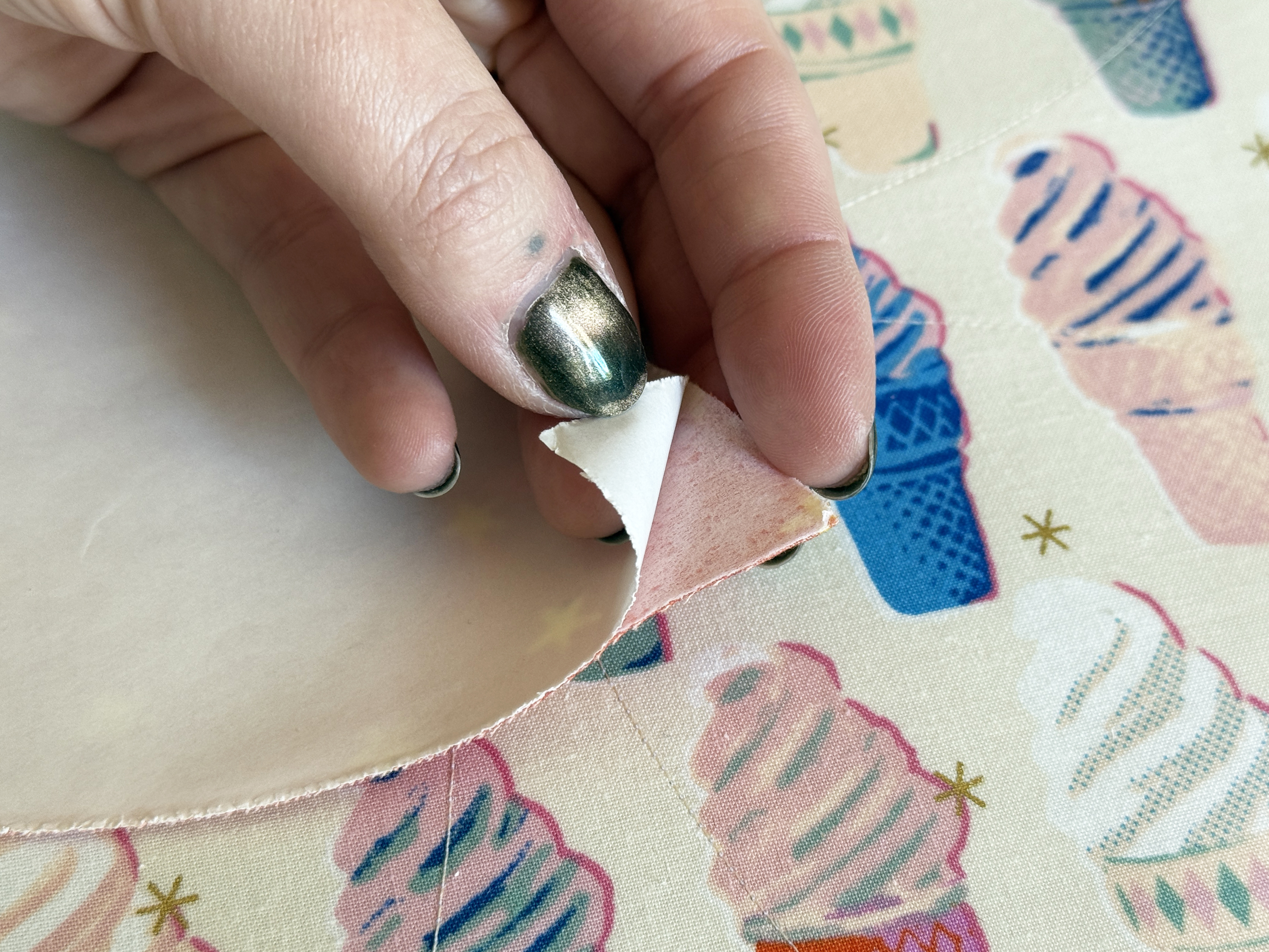 remove paper backing from four applique shapes