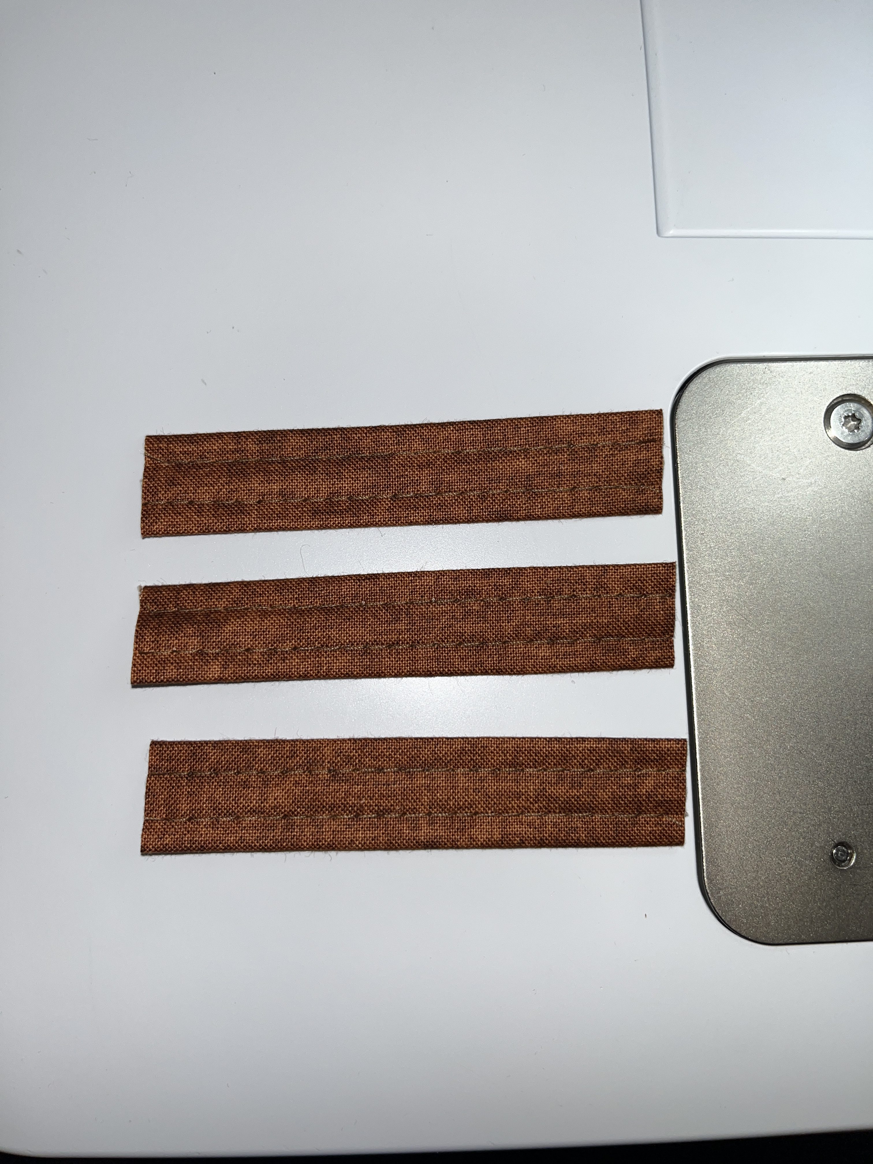 Brown fabric on machine bed