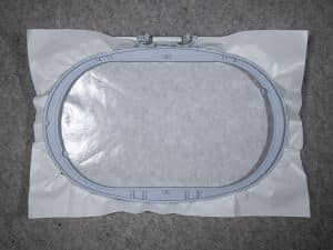 Score the inside of the hoop and remove the top sheet of the stabilizer