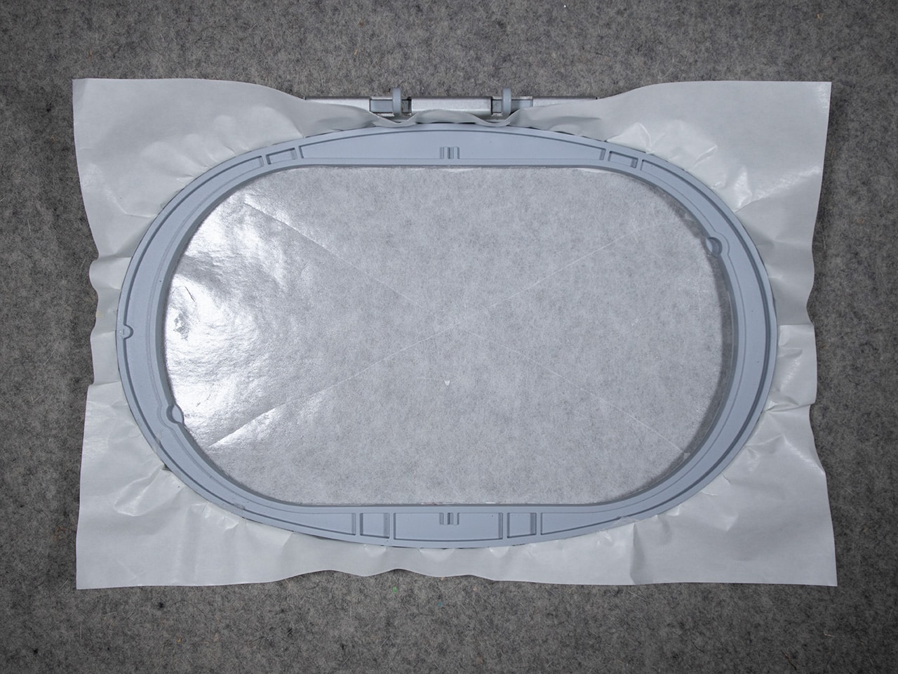 Score the inside of the hoop and remove the top sheet of the stabilizer