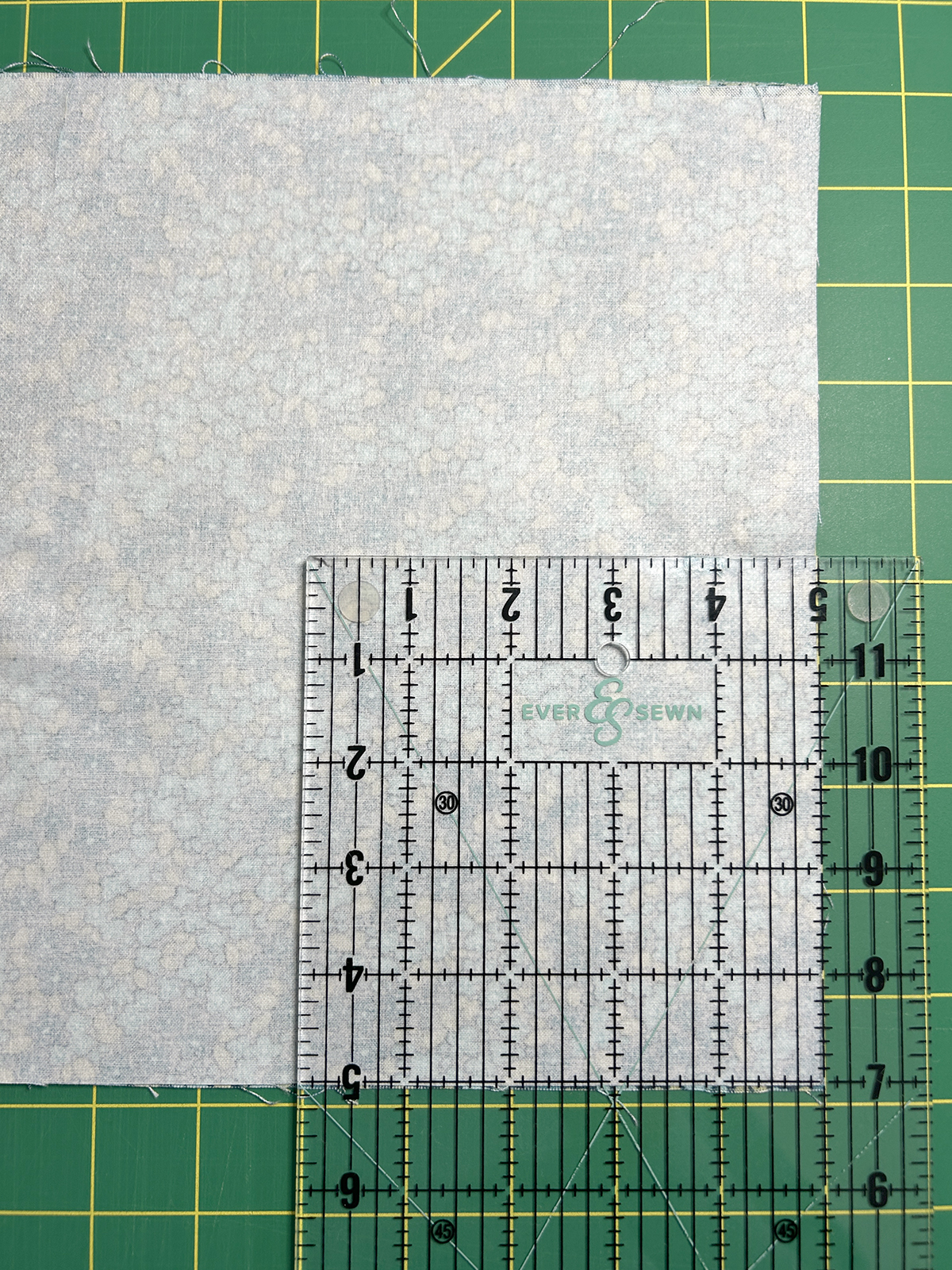 ruler positioned at the center point of fabric