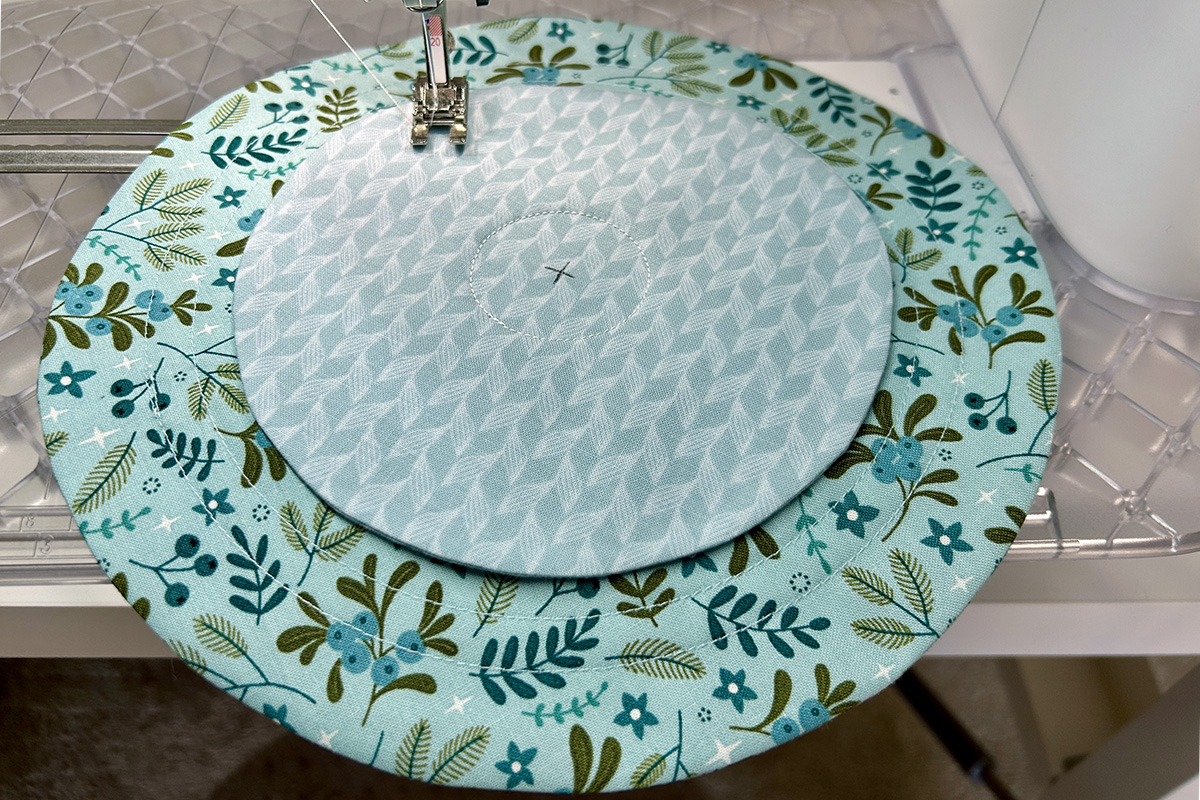small circle on top of large circle with stitched circle