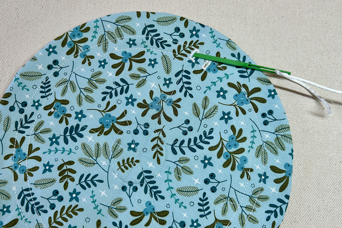 adding drawstring with bodkin into buttonhole